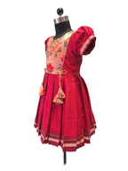 Red traditional Khun knee length frock for girls with peach lotus brocade front yoke - Houser of Kritee