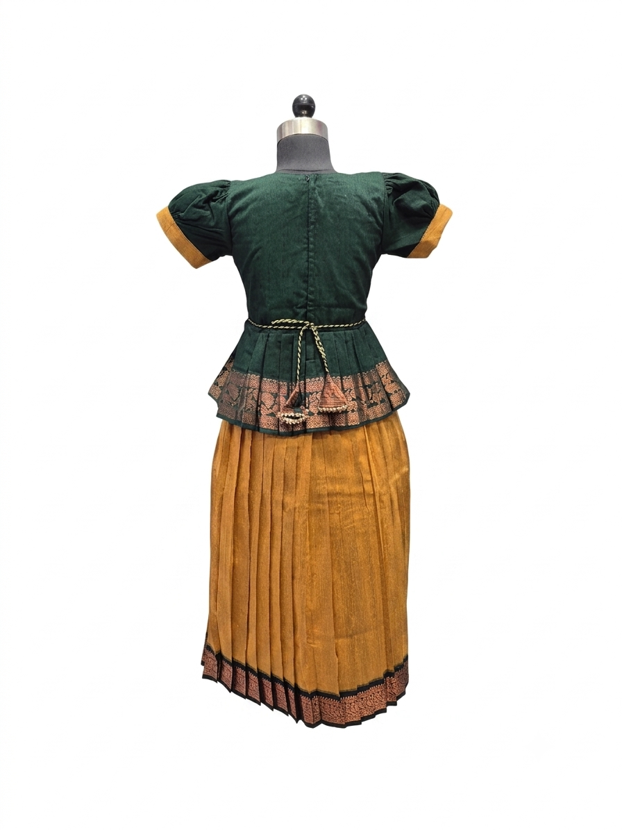 A vintage folkloric costume dress displayed on a mannequin from the back, featuring a dark green short-sleeved top with mustard yellow cuffs, a patterned waistband, and a matching pleated mustard yellow skirt - House of Kritee