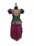 A traditional two-piece outfit displayed on a mannequin, featuring a dark green short-sleeve top with gold embroidery and a pleated magenta skirt with a gold patterned border. - House of Kritee
