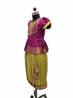 A traditional Indian outfit displayed on a black dress form mannequin against a white background. The outfit features a magenta purple short-sleeved blouse with gold embroidery and a pleated olive green skirt with gold zari borders. - House of Kritee