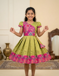 Happy Desi girl model wearing an olive green and magenta pink silk knee length ethnic frock - House of Kritee