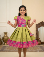 Happy Desi girl model wearing an olive green and magenta pink silk knee length ethnic frock - House of Kritee