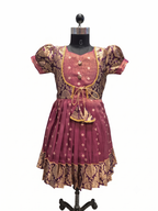 A traditional Indian outfit consisting of a maroon and gold patterned kurta and matching skirt, displayed on a black mannequin against a white background. - House of Kritee