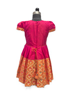 A bright pink and orange traditional dress displayed on a black dress form mannequin against a plain white background. - House of Kritee
