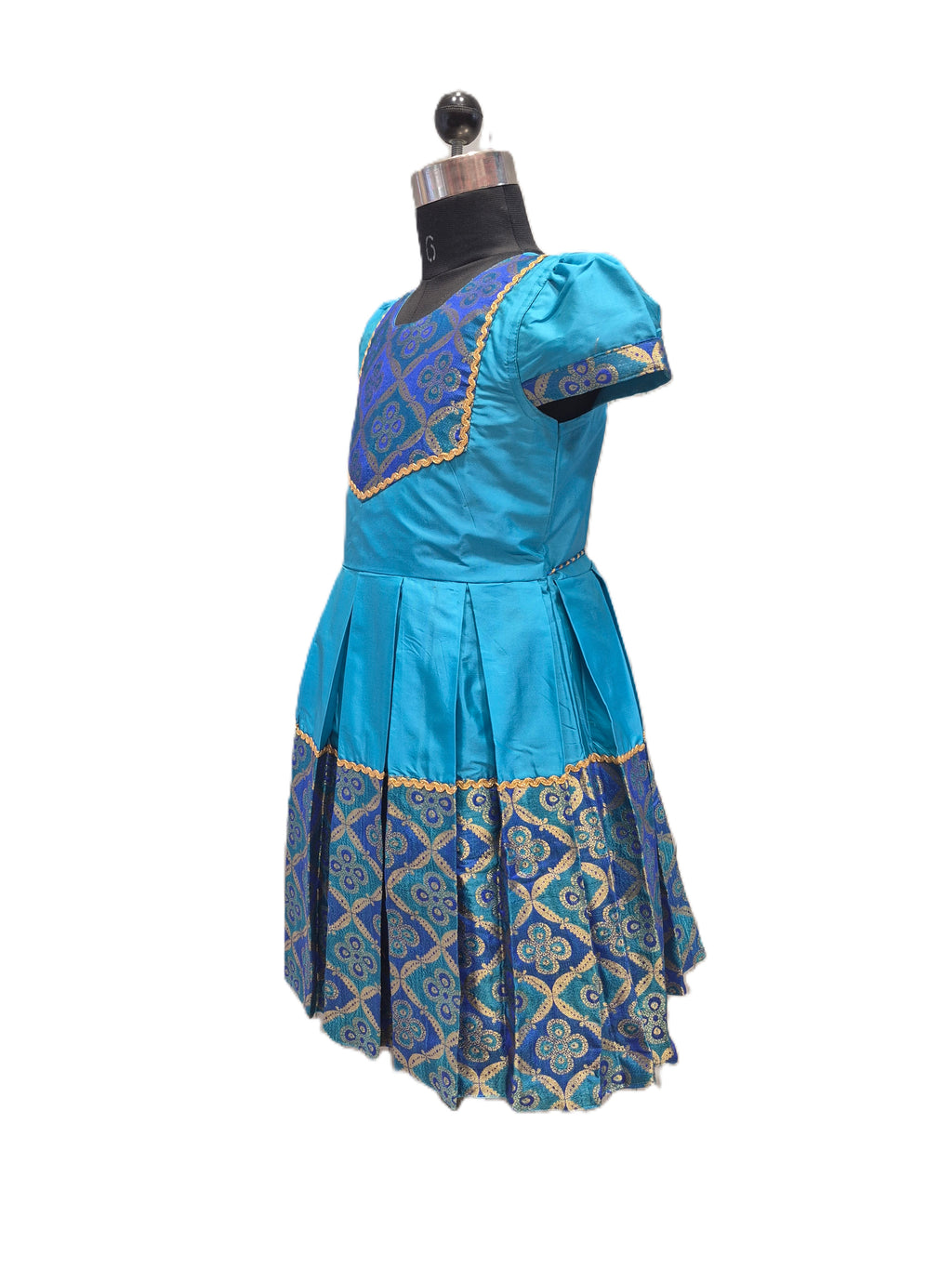 A blue and gold patterned dress displayed on a black dress form mannequin against a plain white background. - House of Kritee