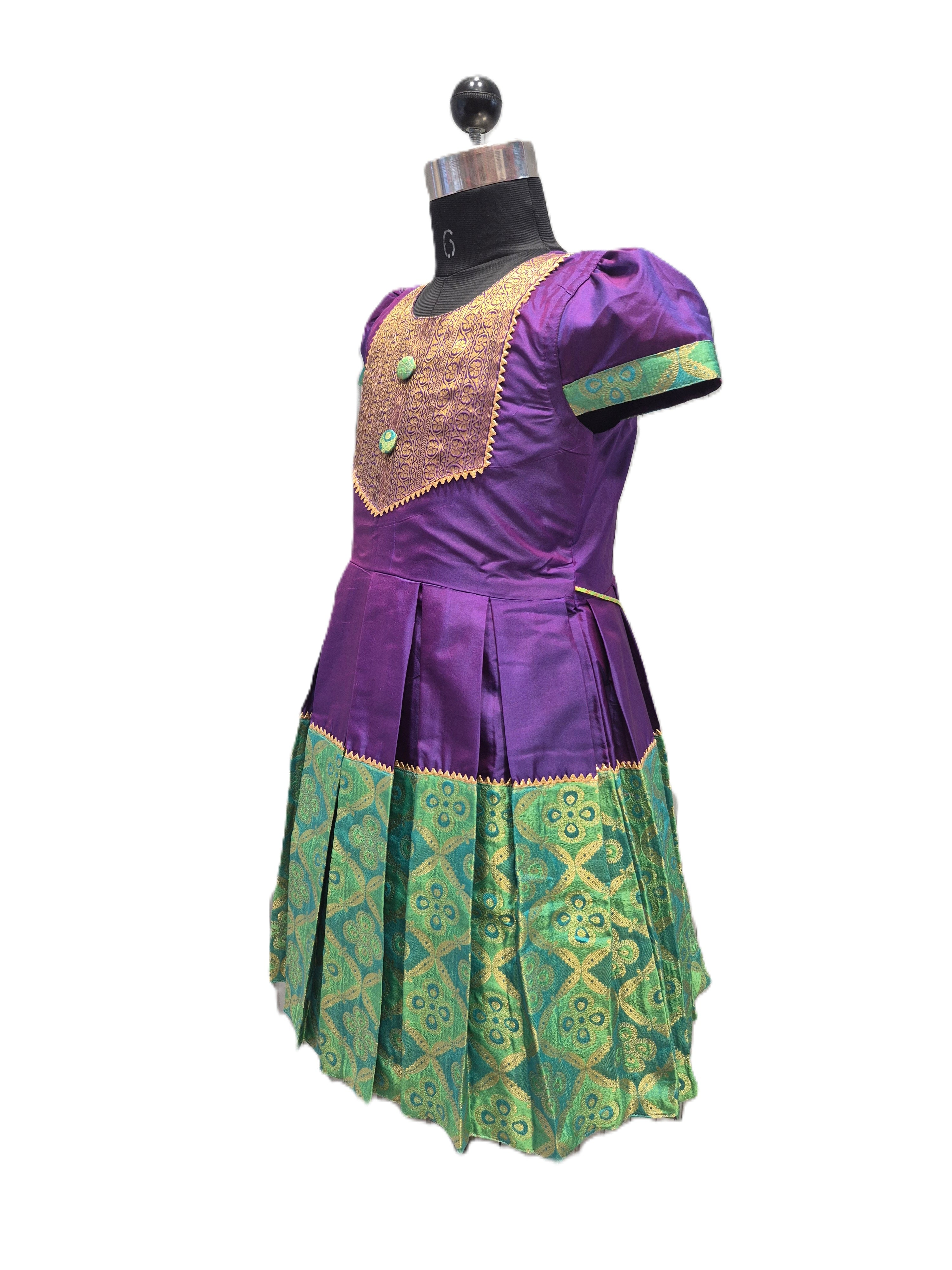 A purple and green traditional dress displayed on a black dress form mannequin against a plain white background. - House of Kritee