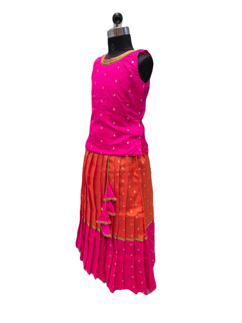 A sleeveless traditional outfit displayed on a black dress form mannequin against a plain white background. The outfit features a bright pink sleeveless top with small gold motifs and a matching pleated skirt in orange and pink with gold accents. - House of Kritee