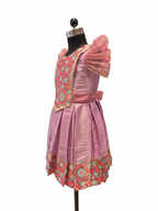 Happy Desi girl model wearing a soft lilac pink silk knee length frock with organza puff sleeves - House of Kritee