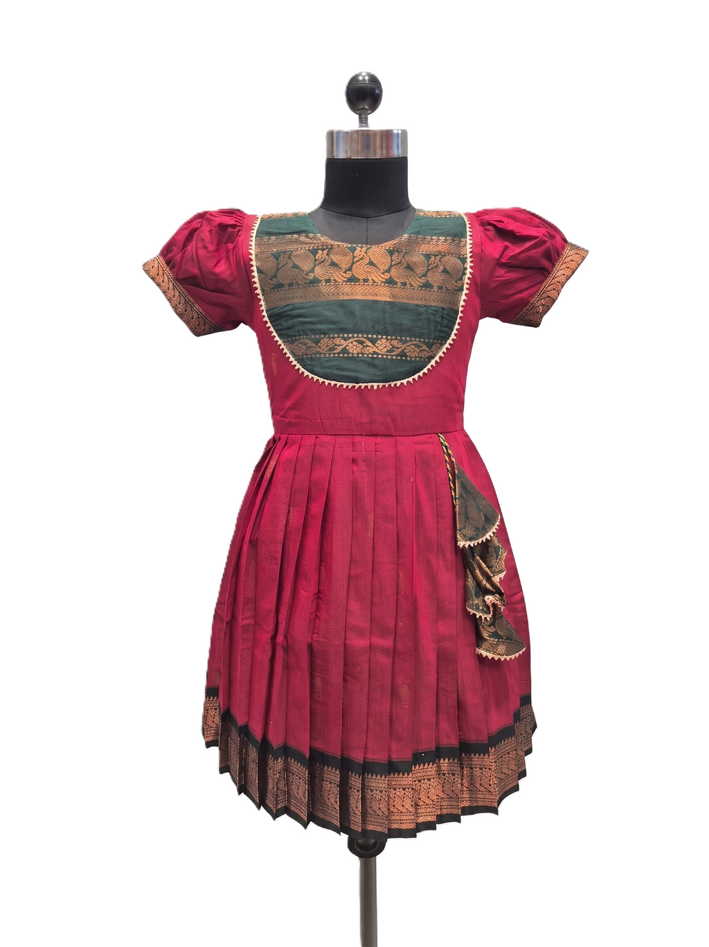 A traditional Indian salwar suit dress displayed on a black mannequin. The dress features a vibrant magenta-pink skirt and sleeves, a contrasting teal green embroidered yoke, and intricate gold zari embroidery throughout. - House of Kritee