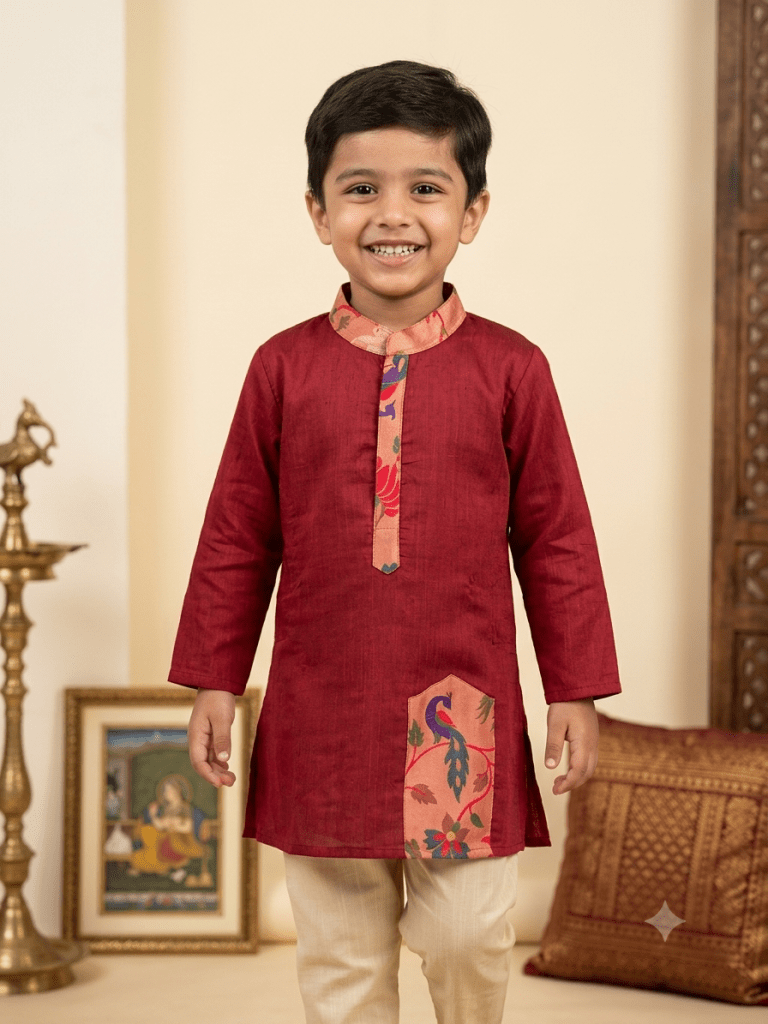 Young Desi boy model wearing festive maroon red silk kurta with printed placket and beige paijama - House of Kritee