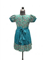Little girl wearing teal ethnic silk frock with traditional floral jacket"