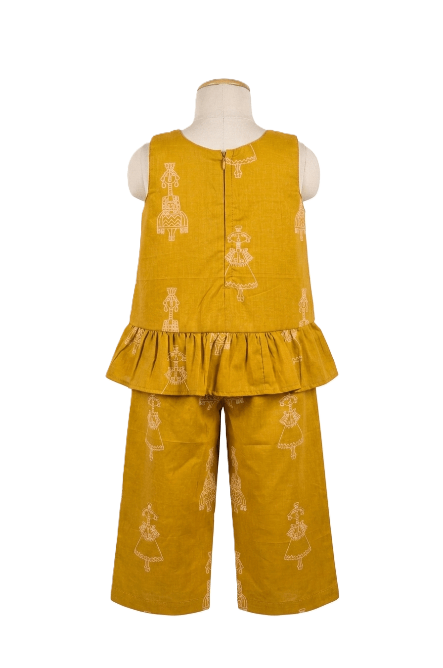 Girls mustard yellow cotton co-ord set with sleeveless peplum top and wide-leg trousers featuring folk ethnic motifs on a mannequin