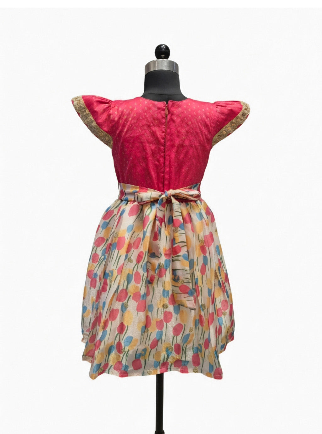 Young Indian girl model wearing pink silk and multi color floral print knee length festive dress - House of Kritee
