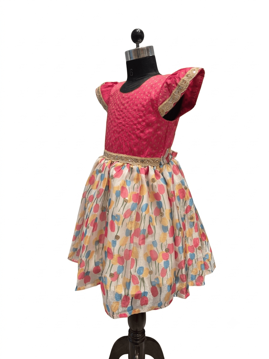 Young Indian girl model wearing pink silk and multi color floral print knee length festive dress - House of Kritee