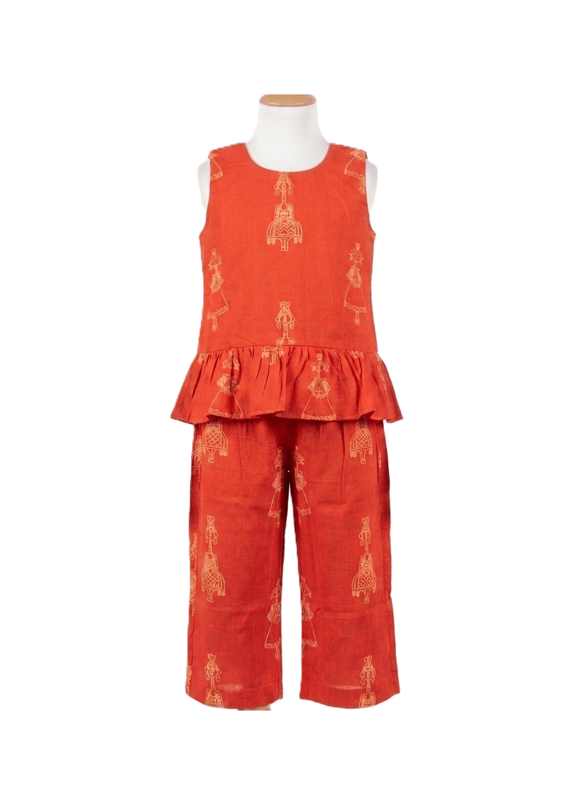 Red outfit with ruffled top and wide-leg pants on a mannequin against a white background