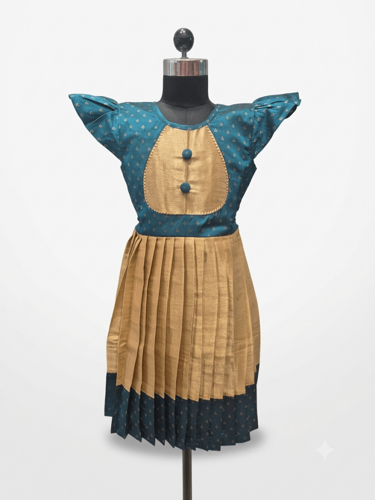 Young Desi girl smiling in a traditional peacock teal and gold ethnic silk frock with flutter sleeves
