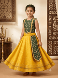Young Indian girl model wearing traditional yellow and dark green parkar polka lehenga dress set with gold lace border