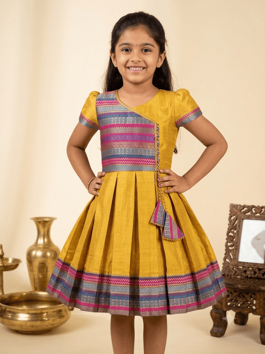 Happy Desi girl model wearing a yellow silk Angrakha knee length ethnic frock with geometric border - House of Kritee