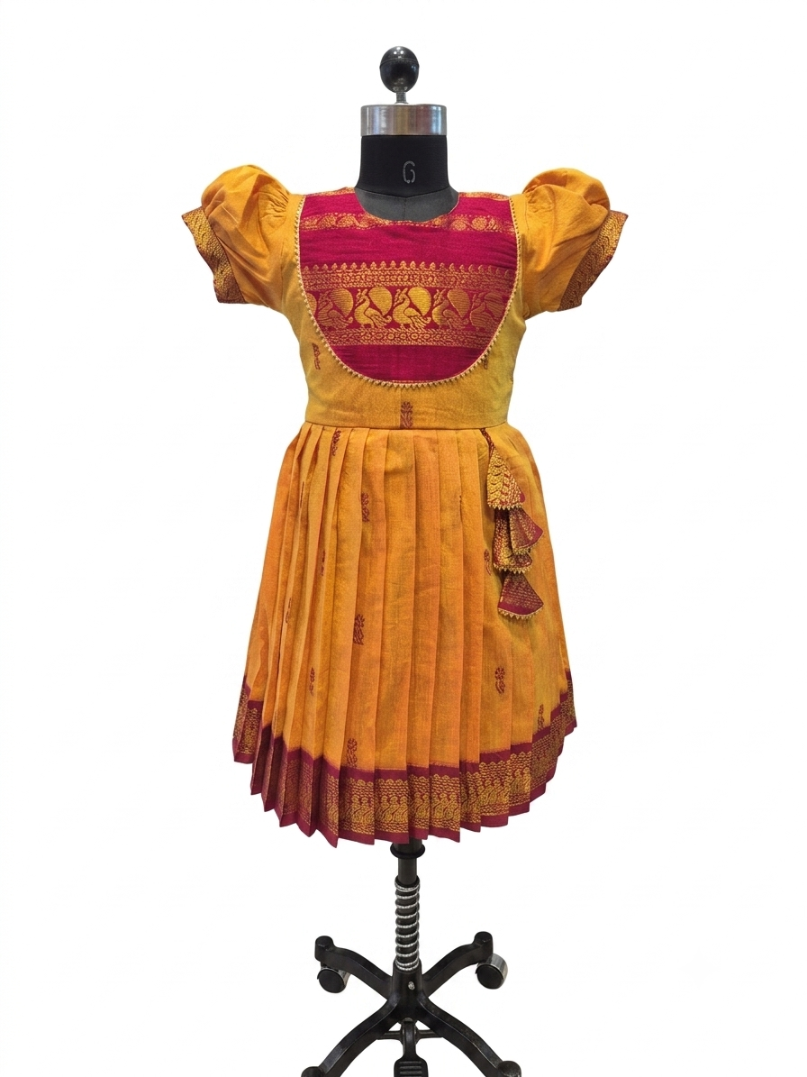A traditional Indian salwar suit set displayed on a black mannequin. The set includes a mustard yellow salwar with a deep red and gold embroidered yoke, matching mustard yellow flutter sleeves, and a pleated skirt with a red and gold border.