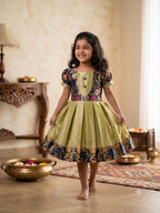 Happy young girl enjoying her premium navy blue and gold brocade silk knee-length ethnic frock in a warm cream living room setup - House of Kritee