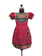 A traditional Indian salwar suit dress displayed on a black mannequin. The dress features a vibrant magenta-pink skirt and sleeves, a contrasting teal green embroidered yoke, and intricate gold zari embroidery throughout. - House of Kritee