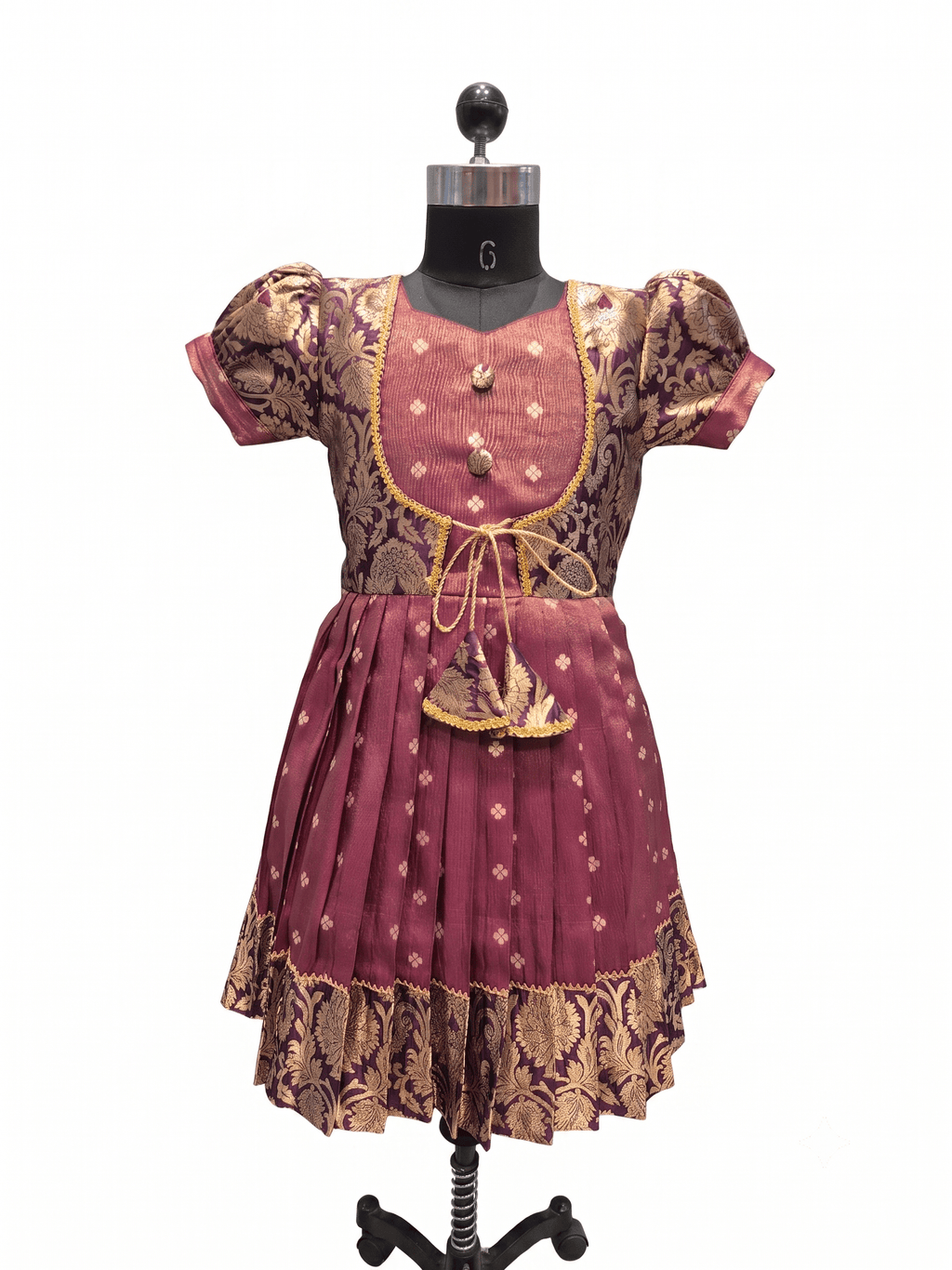 A traditional Indian outfit consisting of a maroon and gold patterned kurta and matching skirt, displayed on a black mannequin against a white background. - House of Kritee