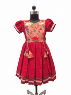 Red traditional Khun knee length frock for girls with peach lotus brocade front yoke - Houser of Kritee
