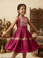 Happy young girl wearing premium silk knee-length ethnic frock dress smiling in a warm cream cream-colored room